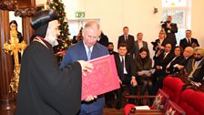 HRH Prince of Wales receiving the Gospel book from H.E. Archbishop Toma