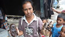 A fisherman shows off two varieties of trepang on the island of of Barang Lompo off the coast of Makassar, Indonesia.