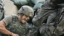 Specialist Underwood shouts to a gunner while launching grenades during an attack by Taliban fighters who oppose US troops.