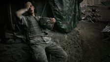 A 2nd platoon soldier rests after fighting at the Restrepo outpost, named after medic Juan Restrepo who was killed in 2007.