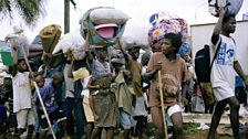 During a government counter-offensive on LURD positions in Monrovia, 3,000 displaced people flee with their possessions.