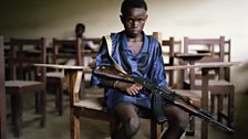 Sekou, 12, an LURD rebel, in an abandoned Tubmanberg classroom. His parents died in the war. He joined the group to survive.