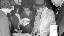 Bing Crosby signs the airport Visitors' Book at Shannon