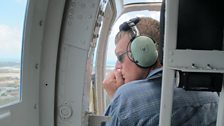 Tom observes charcoal burning from the air