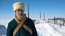 Yusup Askhabov wears the traditional white hat of the Chechens of Kazakhstan - a symbol of salvation