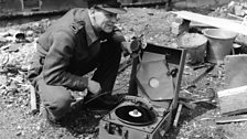 C.D Adamson, engineer correspondent of the 鶹Լ War Reporting Unit, with a midget Recorder