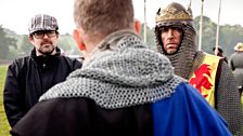 The drama director and the actor who plays Robert the Bruce discuss the next scene with the stunt co-ordinator