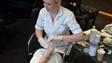 Pedicurist Claire adds some soothing lotion to Simon's feet