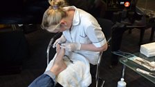 Pedicurist Claire Newman cleaning up Simon's toenails - they look sparkling.