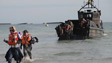 Chris arrives in Arromanches - in the background is the boat that brought Chris in to shore