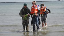 Chris arrives on the beach at Arromanches, accompanied by producer Paul and the military