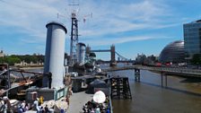 The view east from on top of HMS Belfast, looking out to Tower Bridge, The Tower of London and City Hall