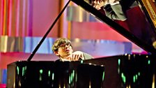 Martin James Bartlett plays the piano on the stage of the Usher Hall