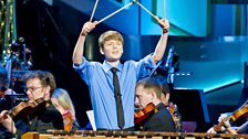 Elliott Gaston-Ross finishes his percussion concerto with a flourrish  on stage at the Usher Hall