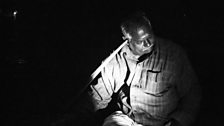 Sangarapillai Vairamuthu, a night fisherman from Batticaloa, listens to underwater music using an oar-handle.