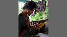 Akala inspecitng a roots drink at the Bobo Ashanti Rasta camp