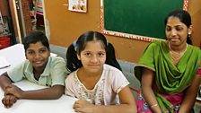 Two young sisters with their teacher