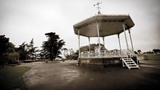 EXT. BANDSTAND AT THE LEAS