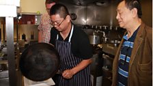 Jeremy Chan dishing out his creation with his father looking on