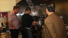 John Toal watching on as Jeremy Chan cooks up a storm in the kitchen