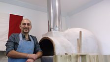 Alessandro posing by the Pizza oven he built