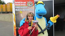 Julie and Dennis the Dinosaur celebrate a successful Treasure Quest!