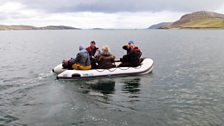 The crew head out by dinghy to board Neil and Paul's lobster boat off the coast of Vatersay