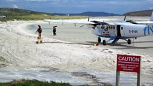 The crew filming on Barra's unique runway; the beach