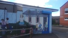 Mural of old bungalows at Taughmonagh shops