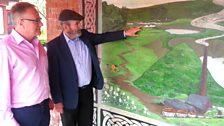 Danny Rock shows Paddy a mural of Westrock bungalows