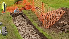 A cobbled street is revealed