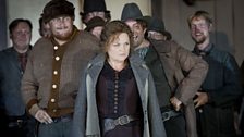 Susan Bullock as Minnie with the patrons of The Polka Saloon in The Girl of the Golden West