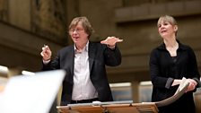 Georg Friedrich Haas offers suggestions to the orchestra. Susanna Mälkki looks on.