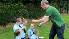 Vincent hands out the radio mics to the kids