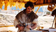 Peter Ginn tries chiselling stone in the stonemason's lodge