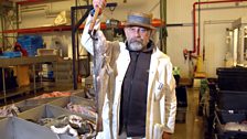 Billingsgate merchant Roger Barton holds a Pollock ready for weighing, New Fulton Fish Market, New York