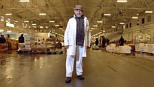 Billingsgate merchant Roger Barton stands in America's largest wholesale fish market, New Fulton Fish Market, New York