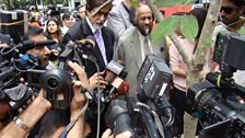 Amitabh Bachchan surrounded by journalists during a press conference in Bangkok.