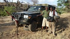 Save the Elephants head of field operations David Daballen and sound recordist Daivd Jalenga sort out a flat tyre