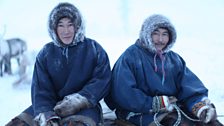 Vitaly and Yeagor sitting on their Reindeer sled