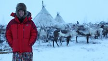 Kate stands near the Chums (tents) that the Nenets live in