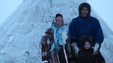 Natasha, Kostya and their daughter Papaneyain front of their Chum; the Nenets family Kate stayed with