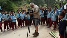 Alexis filming surrounded by school kids