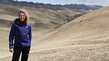 Kate stands in the 'Three Beauties' mountain range of the Gobi desert