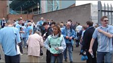 Supporters gather around the entrance to the West Stand