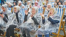 The rain doesn't dampen the audience's spirits