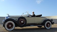 Tessa takes a Leonard Plugge-style trip down the promenade at Fécamp in a 1928 Packard Roadster