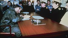 Lt. Cdr Alfredo Astiz signs the surrender document in the Wardroom of HMS Plymouth on the 26th April.