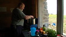 John Arnott in the kitchen at Camasunary Bothy.