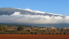 Clouds lie over St Pierre de Vassols in Provence with the iconic Ventoux summit looming large in the background